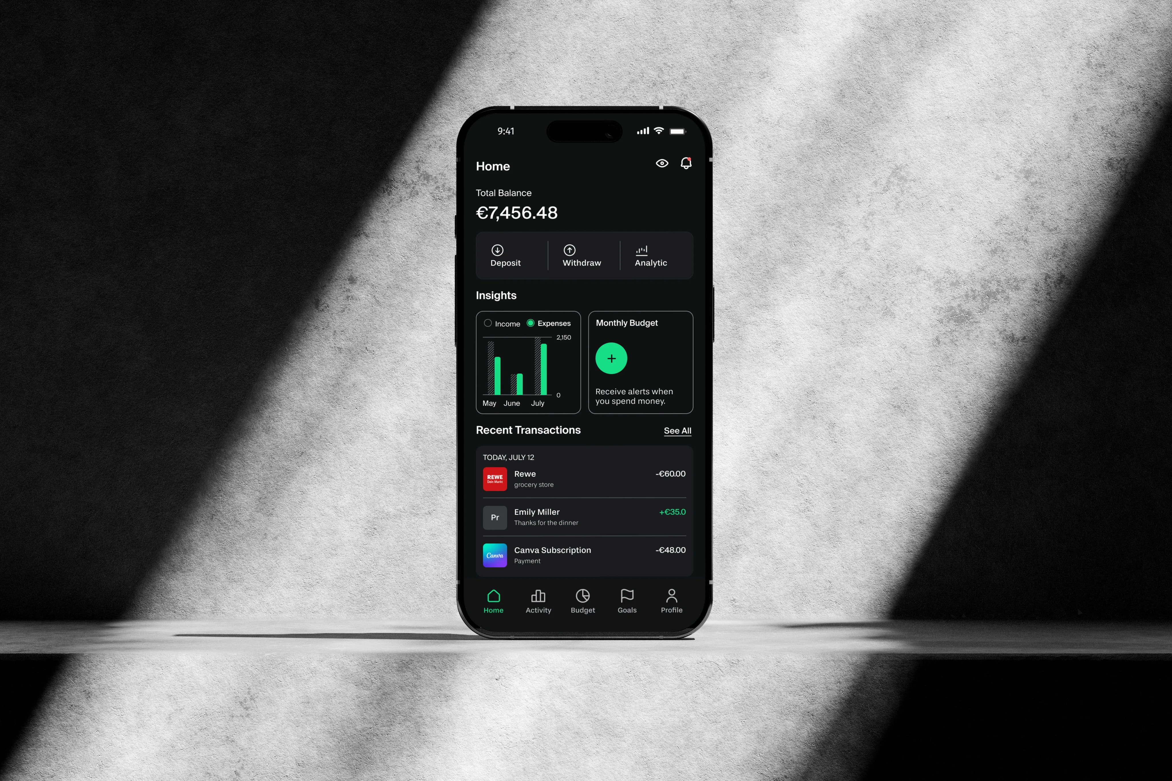 Grava Home dashboard on a phone standing against a concrete wall in raking light
