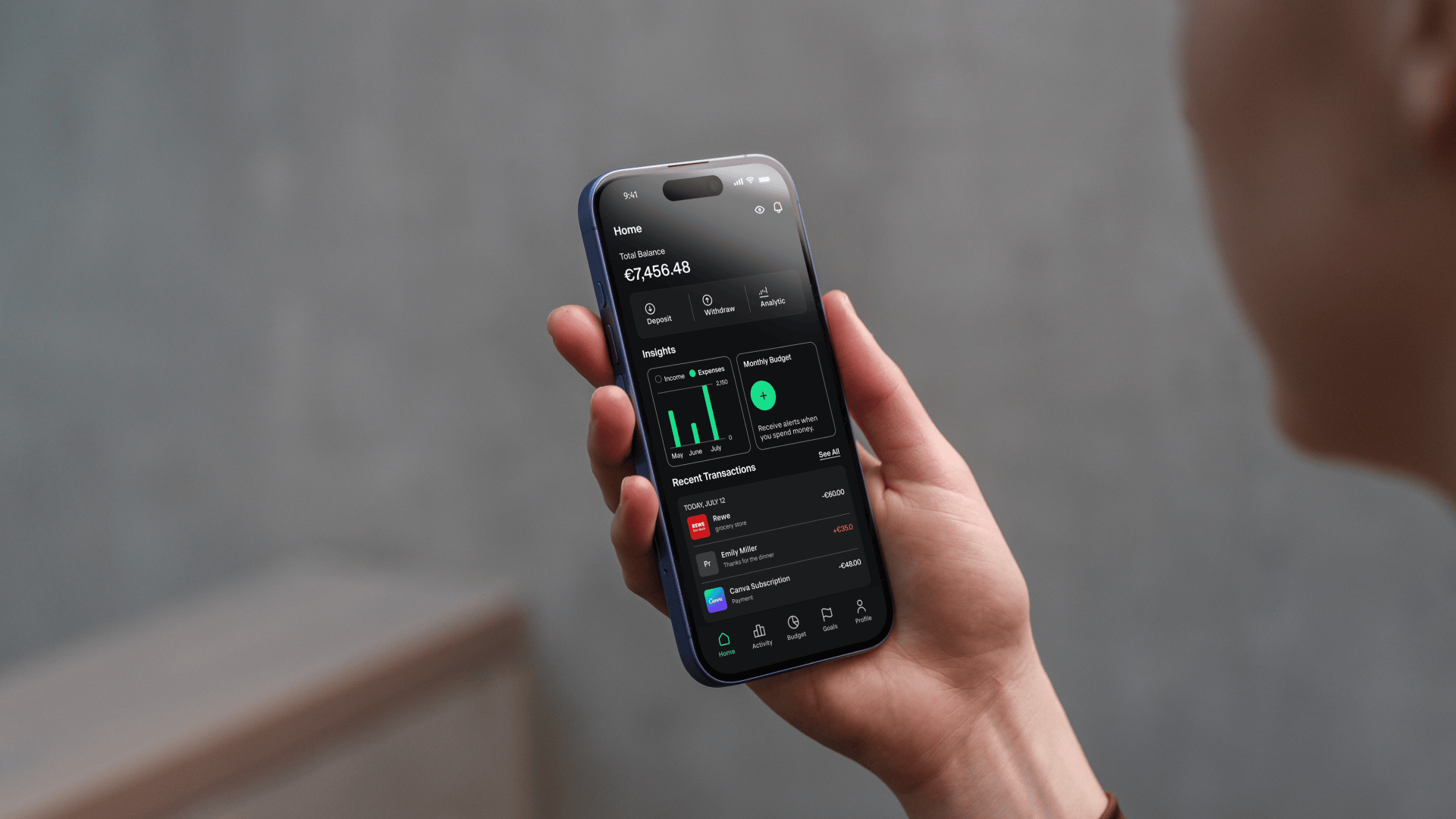 Grava fintech app — Home dashboard held in hand